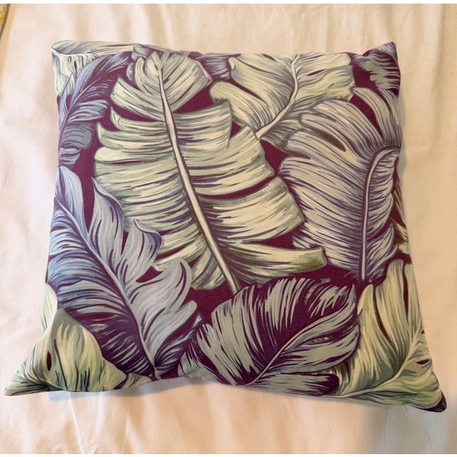 Striking custom-made throw pillow in a sophisticated tropical leaf pattern, blending rich berry, soft lilac, and muted...