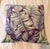 Striking custom-made throw pillow in a sophisticated tropical leaf pattern, blending rich berry, soft lilac, and muted...