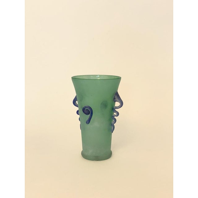 In the spirit of 1980s Italian glass. A vase in satin-finish seafoam green glass adorned with blue glass appliqués forming...