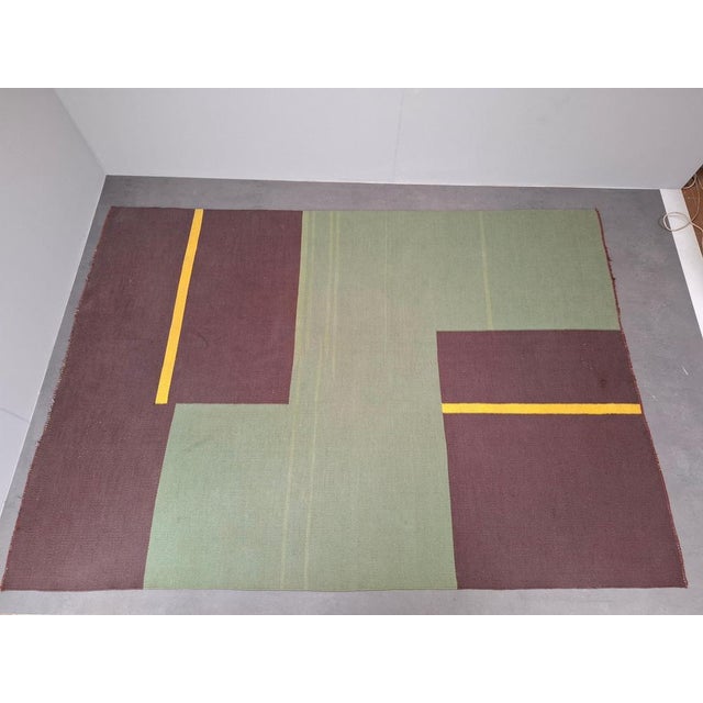 This vintage geometric rug was produced in Czechoslovakia during the 1960s. It features a bold Mid-Century Modern design...