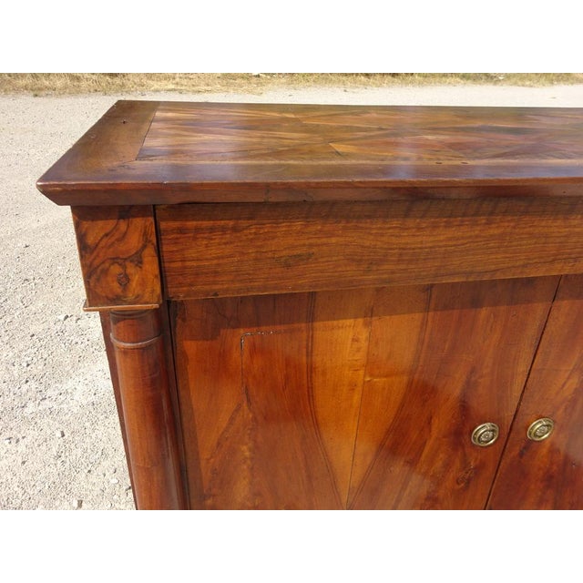 A 19th-century buffet with two doors and one drawer, featuring a curved top. Magnificent marquetry top with chevron and...