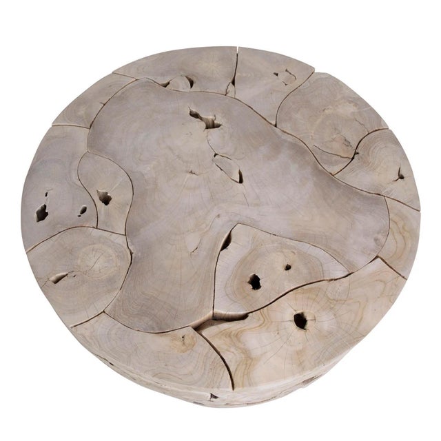Round organic modern coffee table crafted from solid teak root fragments thoughtfully pieced together to create a...