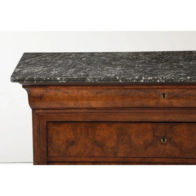 This late 19th-century French Louis Philippe commode exemplifies refined elegance with its rich mahogany construction and...