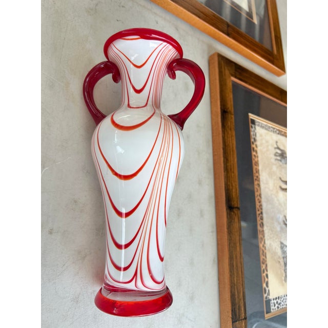Vintage Murano Style art glass vase, hand blown swirl cased glass, orange and white on clear. Has red glass applied handles.