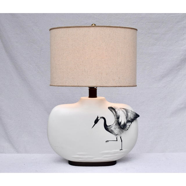 Superb pair of Chapman table lamps of oval form featuring left & right dimensional crane figures. Lamps include natural...