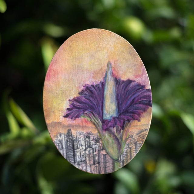 This mixed media piece features a striking floral form emerging against a backdrop of a cityscape, blending natural and...