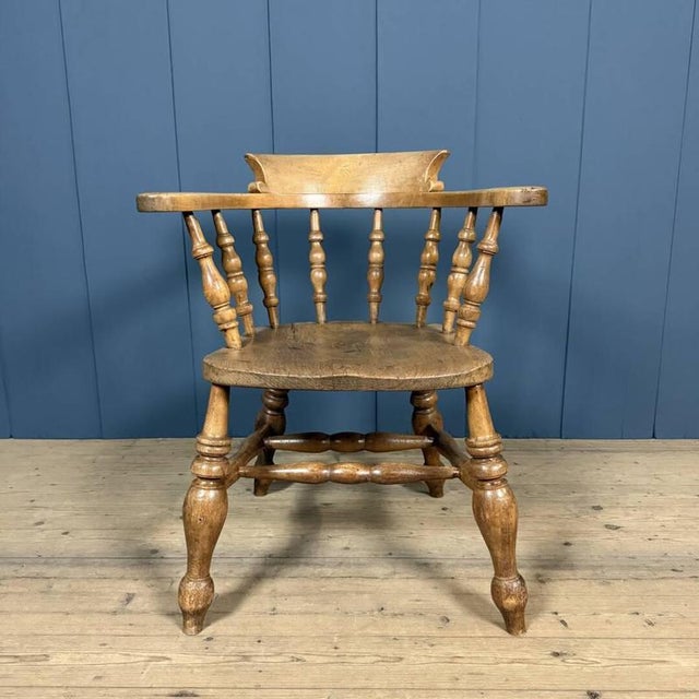 Antique English captain's chair from the early 1900s. Made of beech and elm and marked on the back with "W. Birch, Yoombe,...