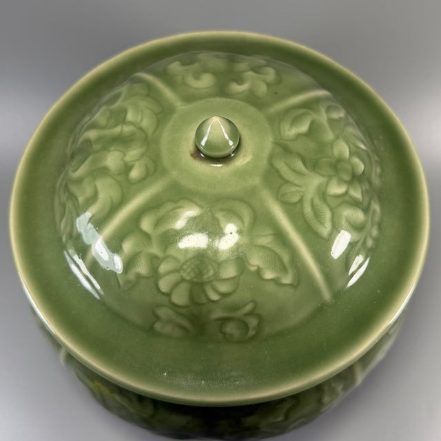 Stunning Chinese celadon lidded jar with matching original lid. The surface is finely carved with scrolling floral motifs...