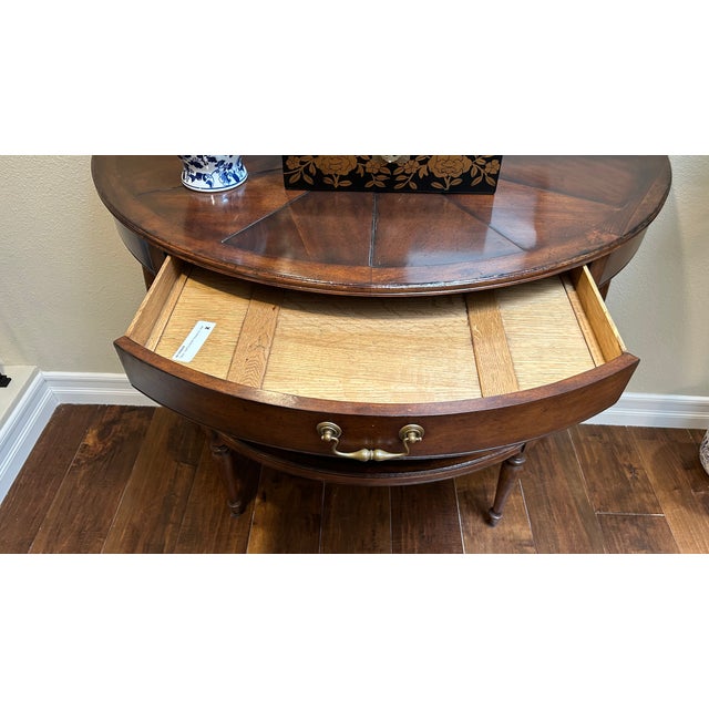 Traditional-style half-round console table of unknown brand, in colour walnut.