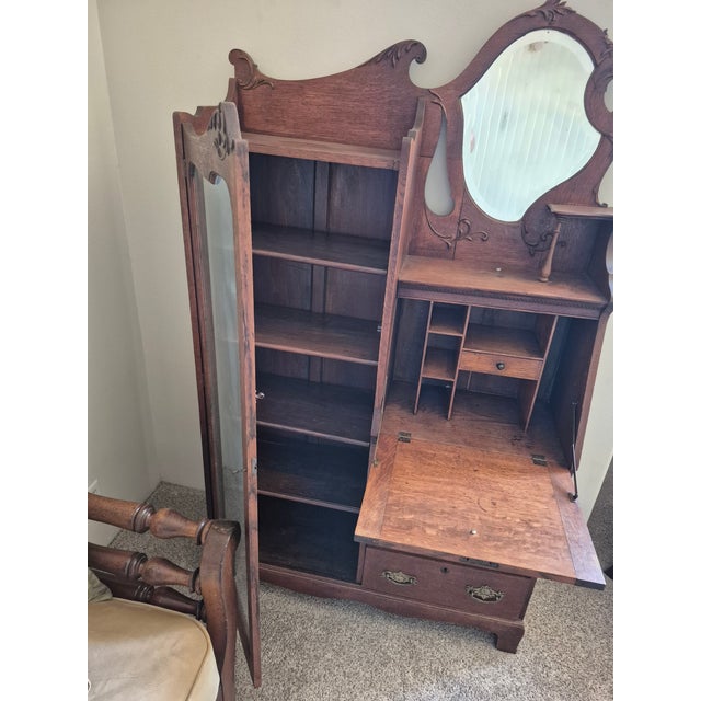 This is an antique American Late Victorian "side-by-side" unit, combining a secretary desk, bookcase, and vanity mirror...