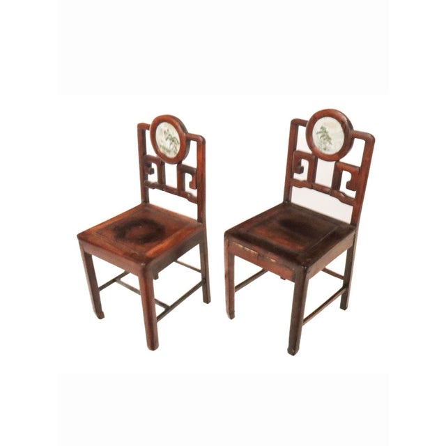 These would make beautiful hall chairs. Each has a carved trelliss back with porcelain medallion. Each medallion is a...