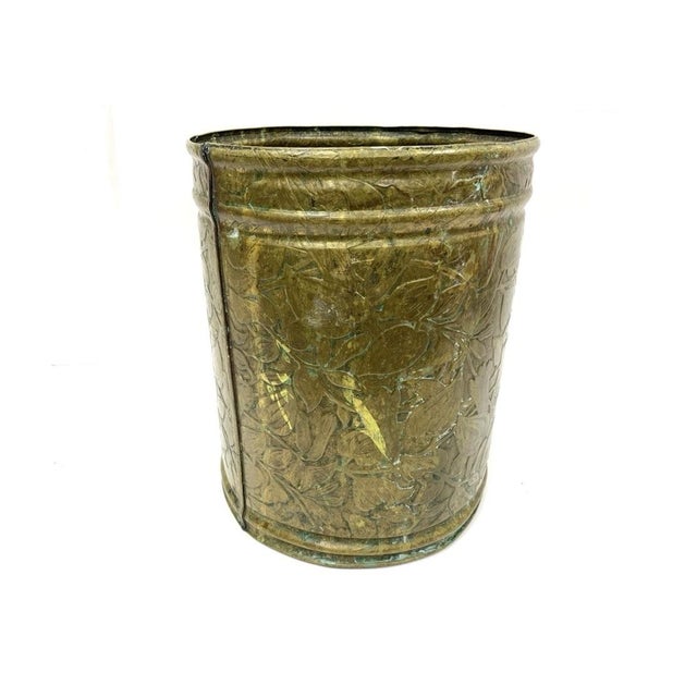 An Arts & Crafts style Brass Wastebasket with intricate Repoussé Floral decoration after the designs of William Morris....