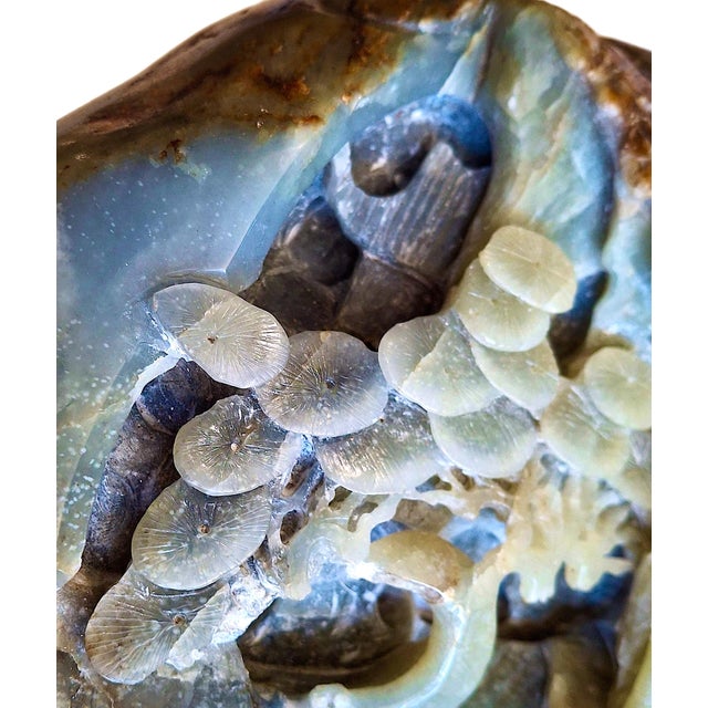 A serene world within a rock is this Chinese jade “boulder carving.” The work represents a traditional art form where a...