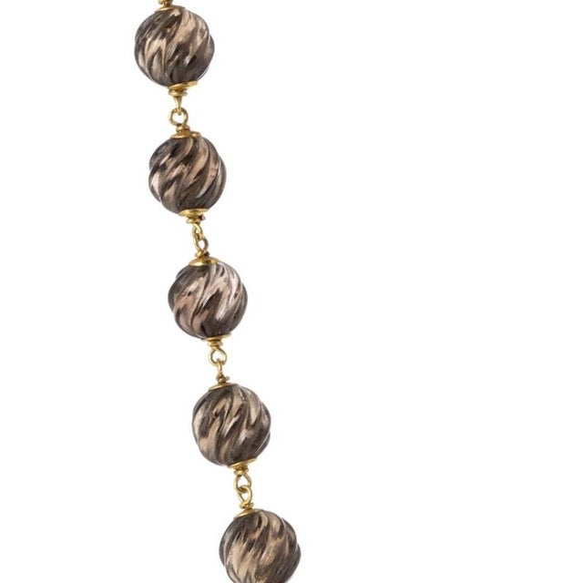 Jewelry - Beaded necklace with 19.2K gold. Portuguese; 20th century; in 19.2 kt gold with carved molten quartz beads; with...