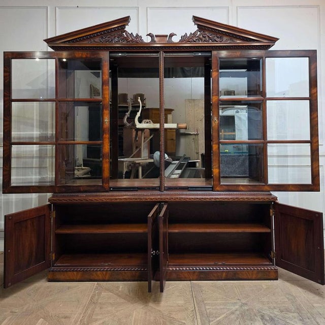 Stunning flame mahogany architectural display cabinet with mirrored back, glass shelves and sliding doors. 1990 Doors open...
