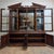 Stunning flame mahogany architectural display cabinet with mirrored back, glass shelves and sliding doors. 1990 Doors open...