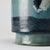 Ceramic pot made by the Menelika pottery in the 1950s. Cylindrical in shape with a slightly flared neck, it features a...