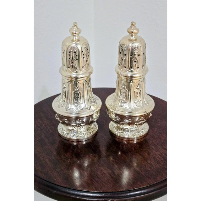 Elevate your table setting with this elegant pair of Japanese silver-plated salt-and-pepper shakers, crafted by C & Co...