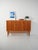 Highboard with oak frame and flamed teak doors. Three doors with curved oak handles, light lines. Highboard with oak frame...