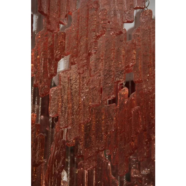 This Murano glass chandelier was produced in the 1970s by Mazzega. It features pink glass elements hanging on chains from...