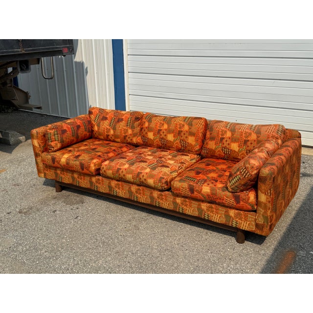 Striking vintage Mid-Century Modern pit sofa by Selig of Monroe featuring a bold geometric pattern in a warm palette of...