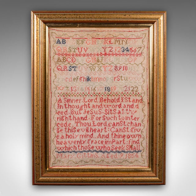 This is an antique needlework sampler. An English, framed embroidered panel, dating to the Victorian period, circa 1850. A...