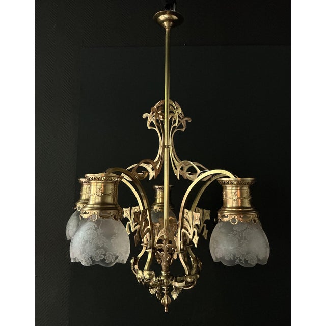 Art Nouveau chandelier in brass and bronze by the "Auermann-Gesellschaft Berlin." Around 1900, this lamp was originally...