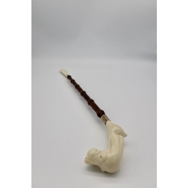 This vintage shoe horn displays a canine bust and comes with an original "Made in Italy" sticker. It is fully functional,...