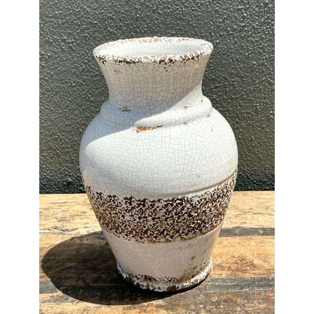 This vintage ceramic vase is a striking example of Organic Modern craft, blending a refined silhouette with rugged,...