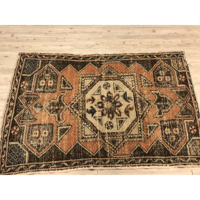 This is a vintage Turkish Oushak rug from the 1960s. The piece was hand-knotted.