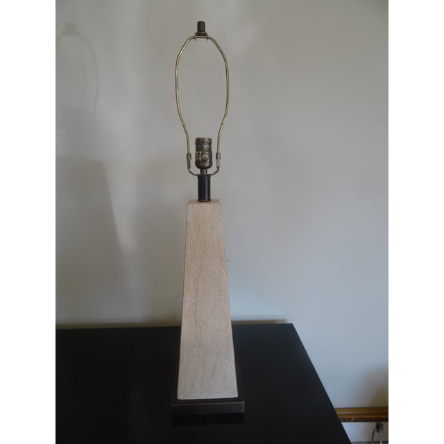 This simple stone veneered lamp works well in both a modern and traditional setting. The Base is an antique brass finish.