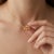Add a burst of warm brilliance to your jewelry collection with this radiant three-stone pendant necklace, showcasing two...