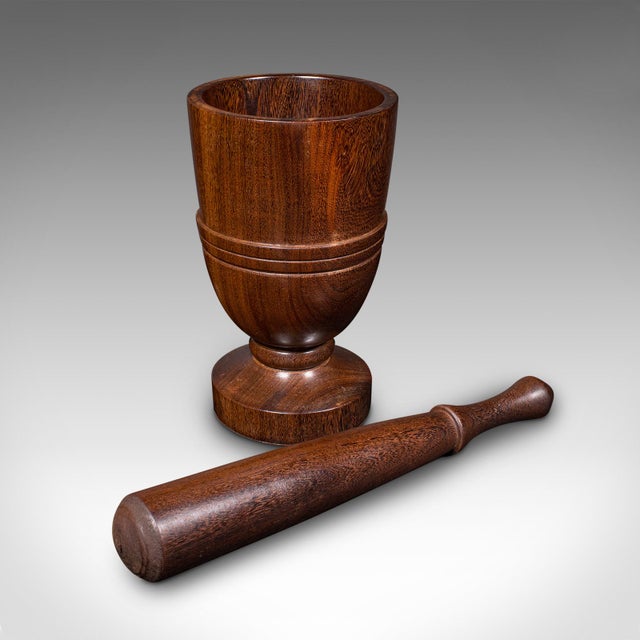 This is an antique turned mortar and pestle. An English, black walnut apothecary or kitchen aid, dating to the late...