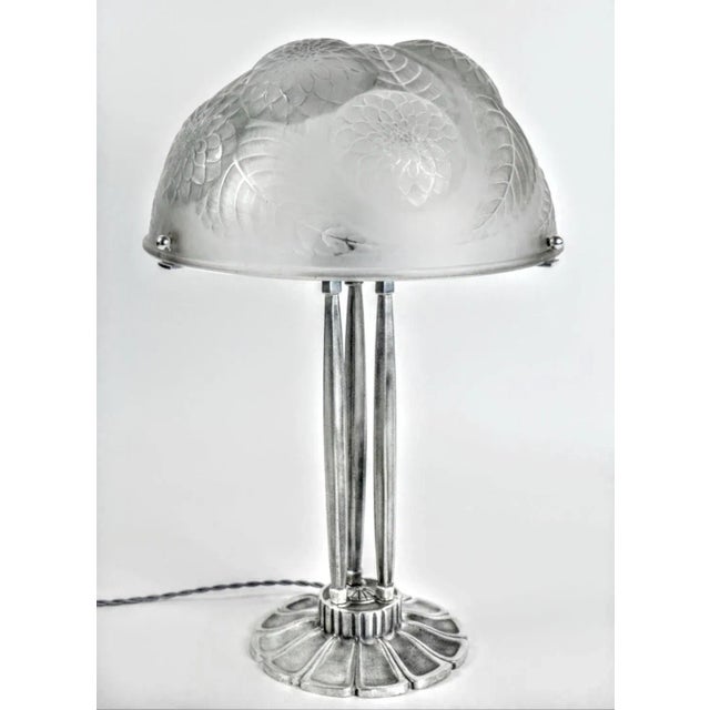 French Art Deco table lamp created by French Glass Master R. Lalique model named "Dahlias". In clear and frosted glass...