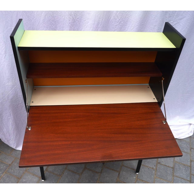 Space-saving vertical writing desk featuring an interior compartment with one shelf, an opening top (lockable) that serves...
