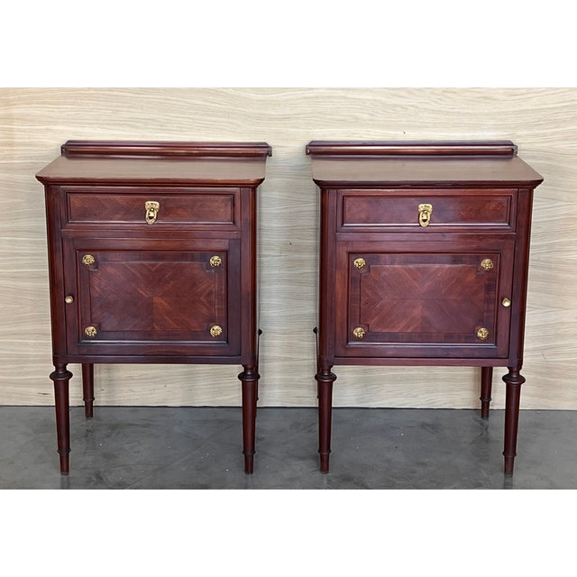 A 19th century French Louis XVI style mahogany side tables, or nightstands, with a fine crest that you can remove. One...