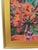 Still-life painting on canvas of an original Impressionist floral artwork featuring orange and red flowers in a clear...