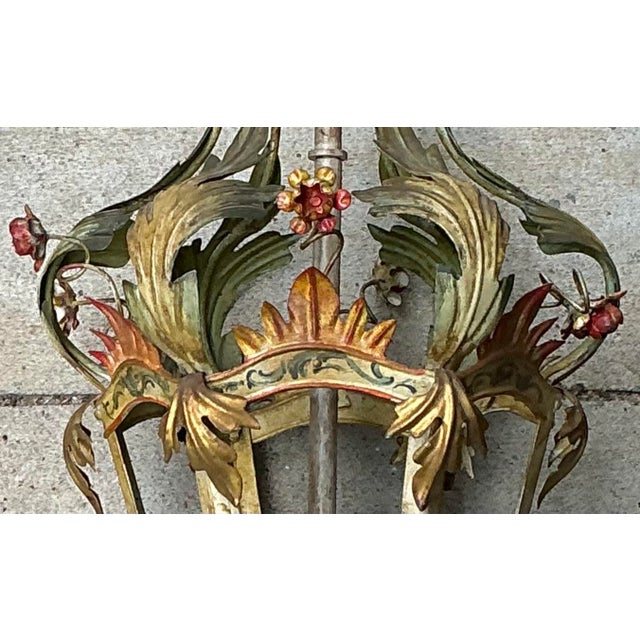 There are two available! This is a Hollywood Regency era Italian tole polychrome lantern. It has three interior candle...
