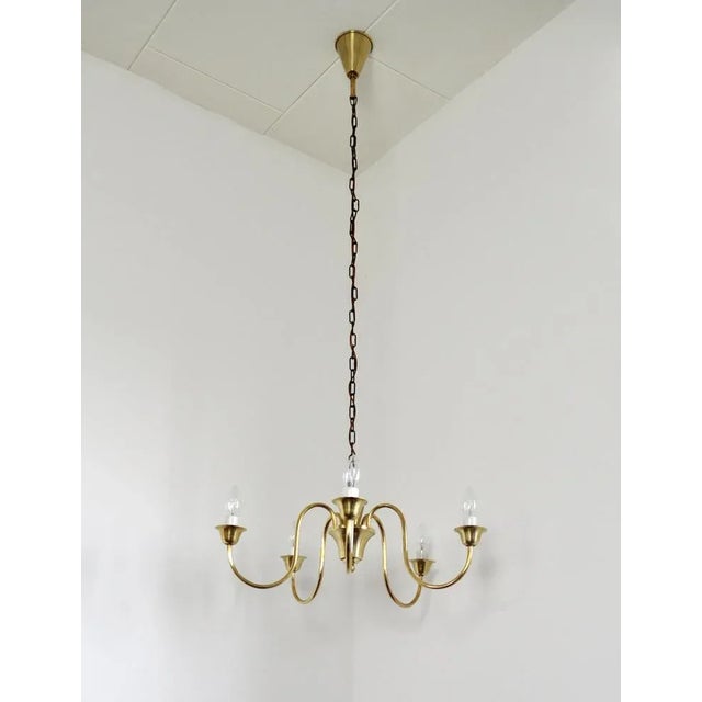 Solid brass five-arm chandelier probably by Fog & Mørup, Denmark, 1950s. Dimensions: Height 19 cm, diameter 55 cm. Full...