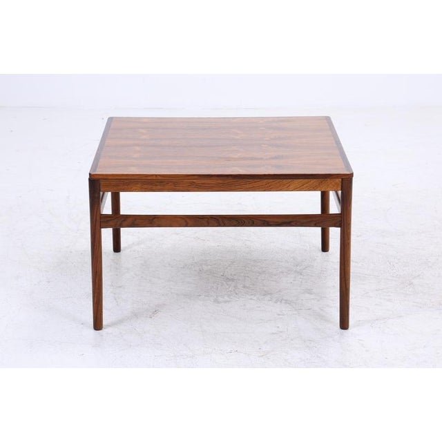 Beautiful vintage rosewood coffee table from the 1960s High-quality workmanship • Danish design • Material: Rosewood...