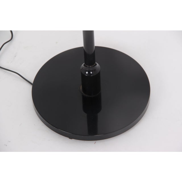 Beautiful Danish floor lamp made of black metal with plastic details and a white plastic shade. A lovely vintage stand in...