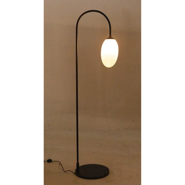 This elegant metal floor lamp has been expertly artisan crafted and finished in matte black. This lamp is a dazzling...