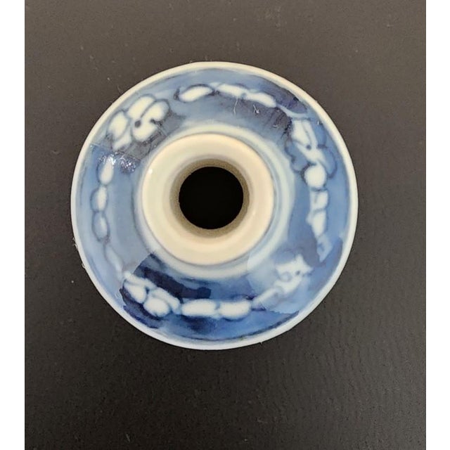 A stunning decorative artifact from the Guangxu period (1875-1908). This striking cylindrical bottle is a sophisticated...