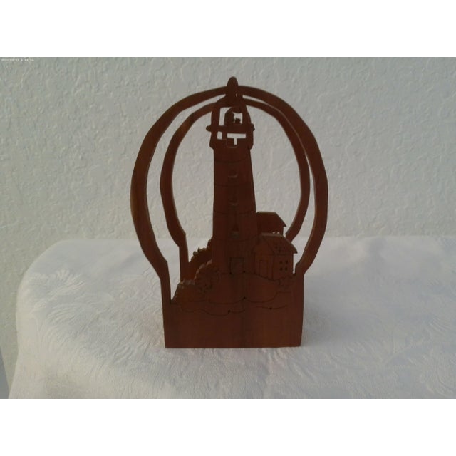 Charming hand-made wood napkin holder featuring a cut-out lighthouse.