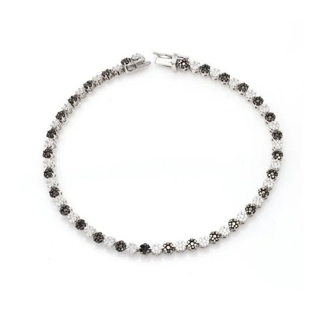 This is part of Chairish’s Fine Jewelry assortment. Brilliant 2.16 ct Black White Diamond Tennis Bracelet in 18K gold. It...