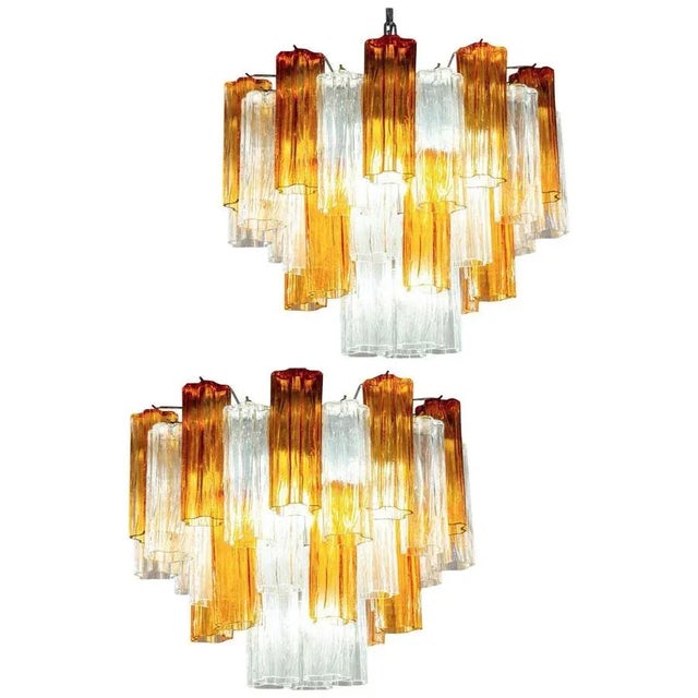 Amazing pair of chandelier includes precious gold amber color and clear tronchi Murano glasses 20 cm long. Nickel-plated...