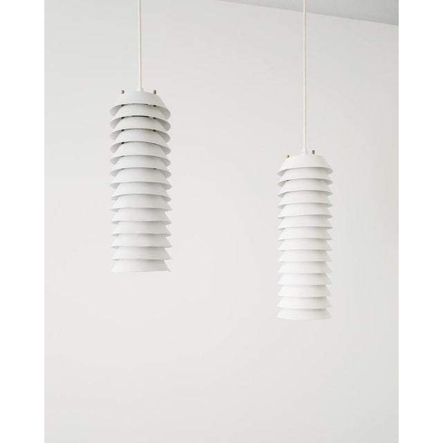 Rare pair of Finnish mid century cylindrical "Maija The Bee" ceiling pendants in white lacquered aluminum shades and brass...