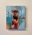This oil on board piece captures two figures in a moment of intimate connection, their forms elegantly intertwined against...