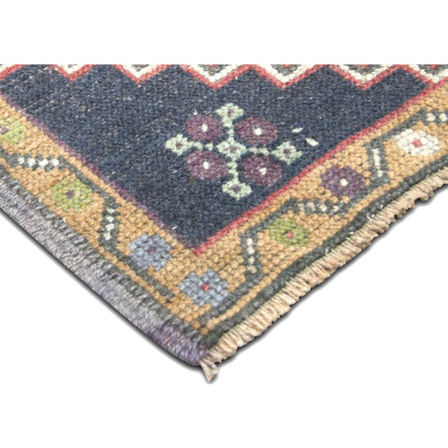 Hand-woven wool-on-wool vintage Yastic from Turkey's Oushak region. Measures 1'9" x 3'11". Features the geometric patterns...