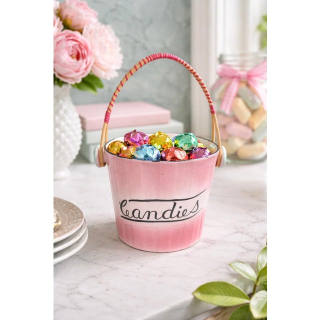 Charming vintage ceramic candy bucket featuring a soft pink ombré glaze with hand-painted black script reading “Candies.”...
